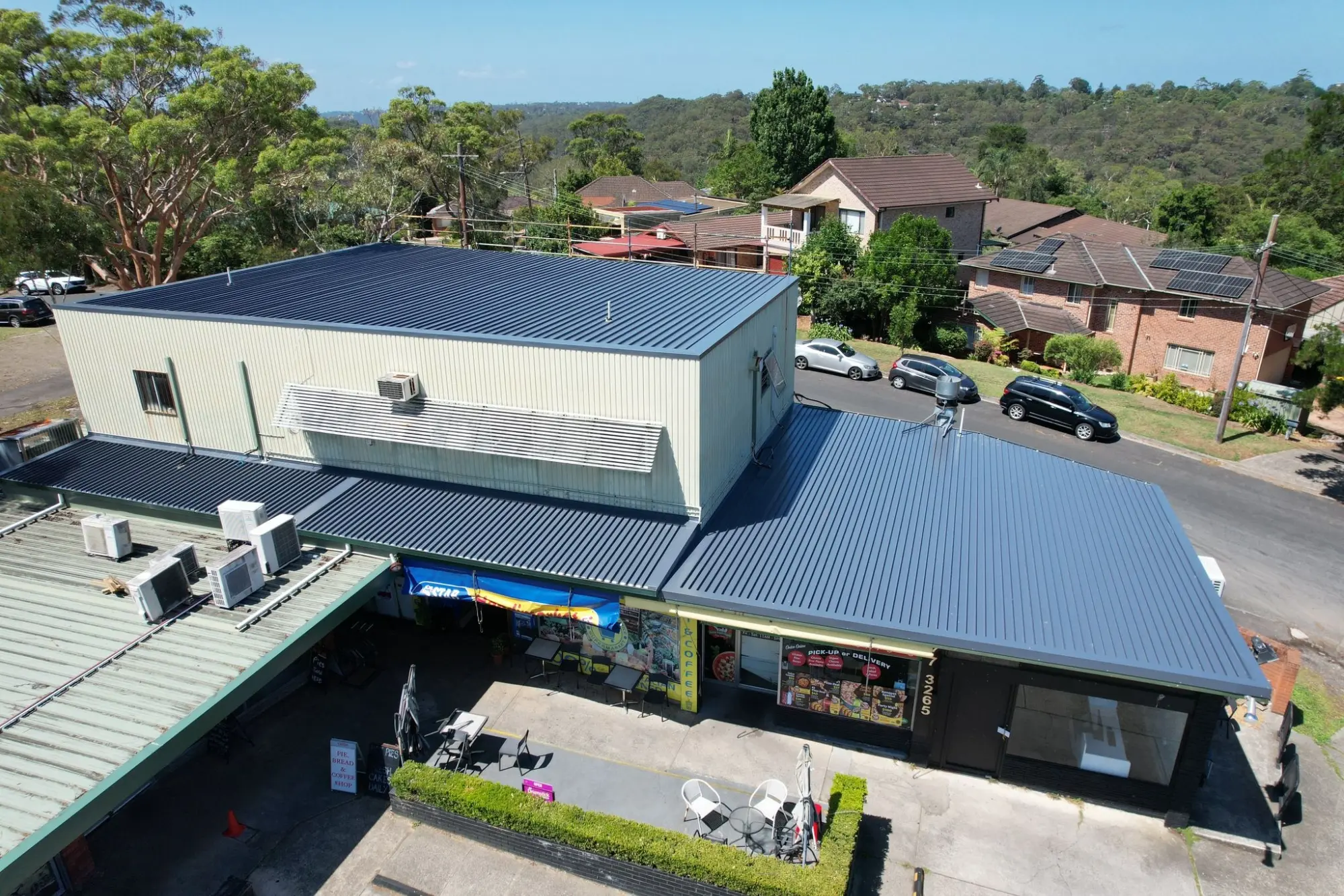 Aerial view of new residential homes featuring Colorbond metal roofing installation by Prestige Roofing Solutions in Sydney, NSW.